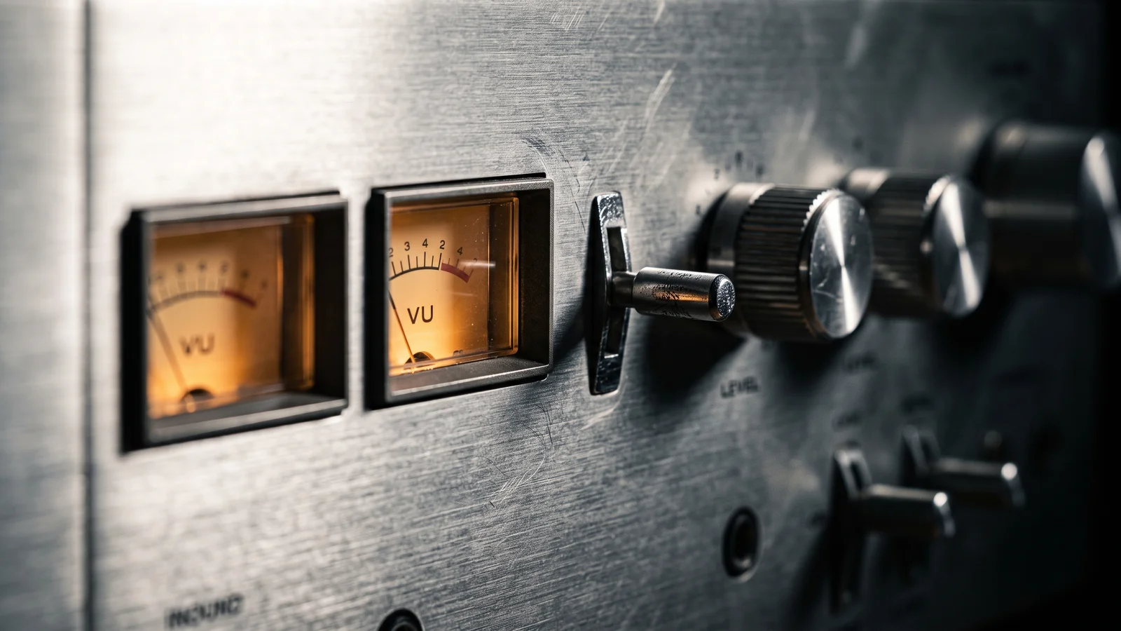 Close-up of a vintage cassette deck faceplate showing Dolby noise reduction switches and level meters