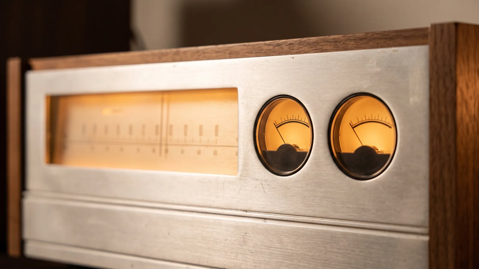 A 1970s silver-faced stereo receiver with a glowing tuning dial and VU meters, representing the golden age of the Receiver Wars