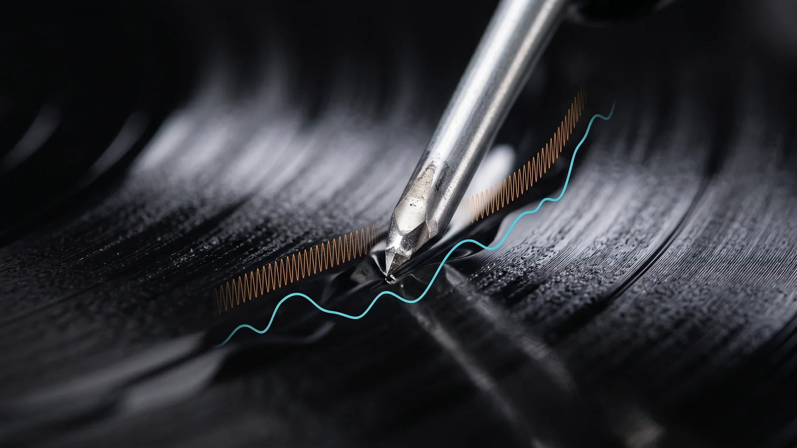 Extreme close-up of a phonograph stylus riding in a record groove with a stylized ultrasonic carrier waveform drawn riding above the normal audio waveform