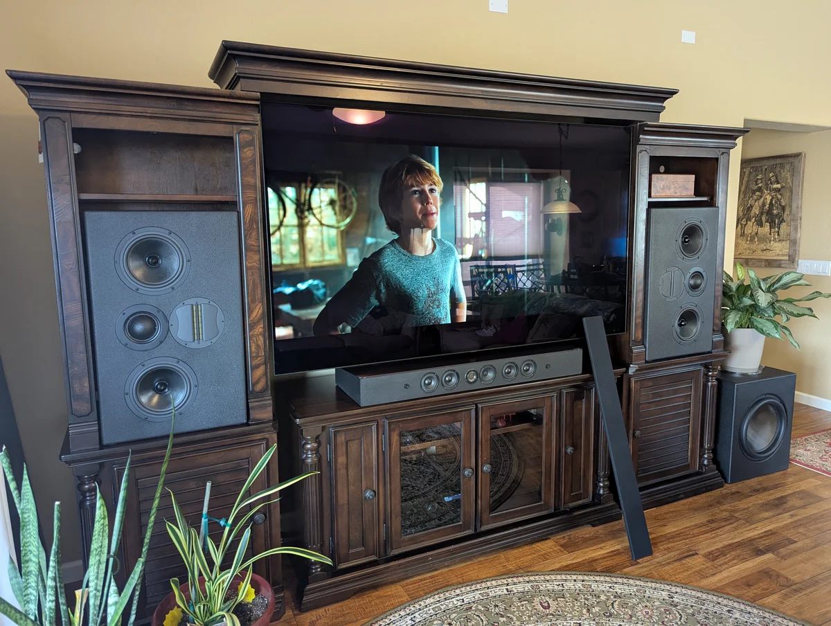 Completed WubWub Audio custom speaker system installed in entertainment center playing a movie