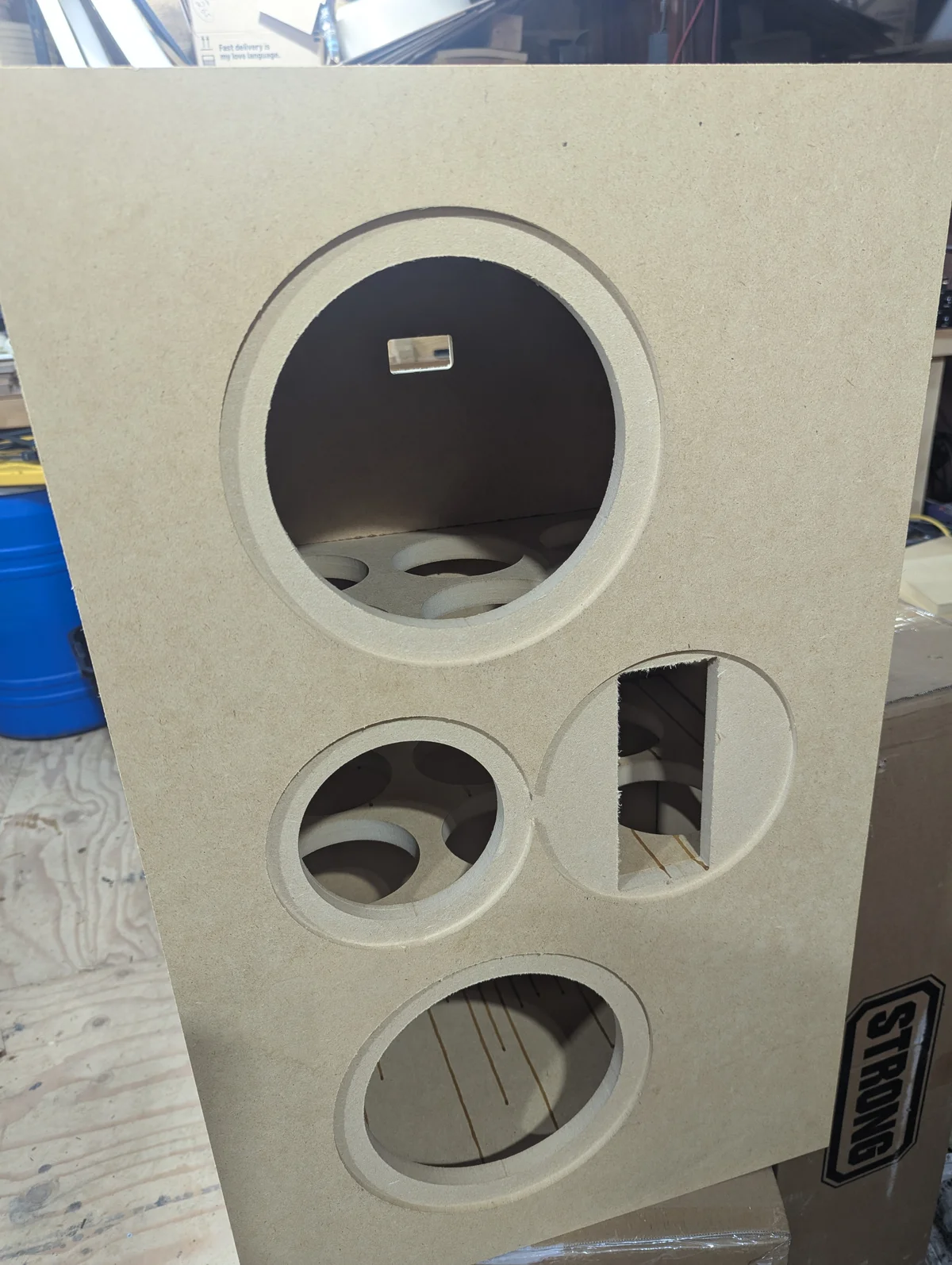 CNC-cut front baffle showing precision driver cutouts with internal bracing visible