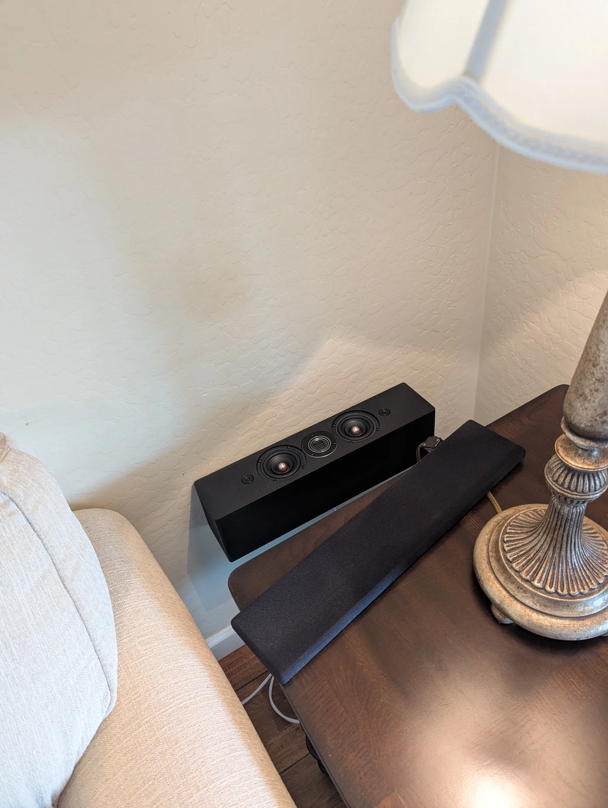 WubWub Audio compact surround speaker installed on side table in living room