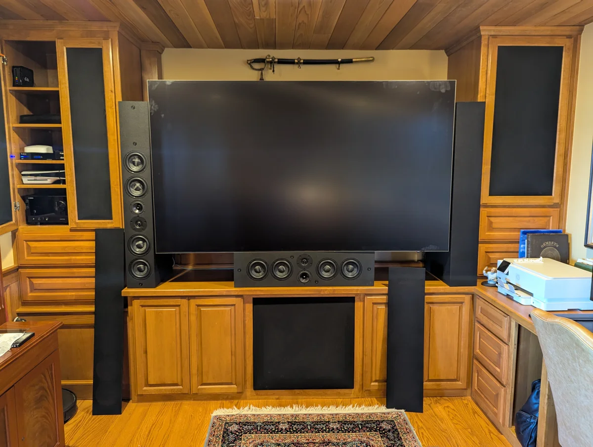 Custom WubWub Audio tower speakers flanking large display in finished home theater room