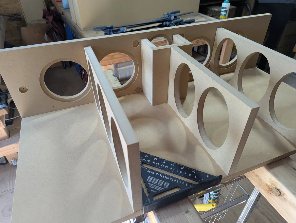 Custom speaker cabinet showing internal bracing and driver cutouts before assembly