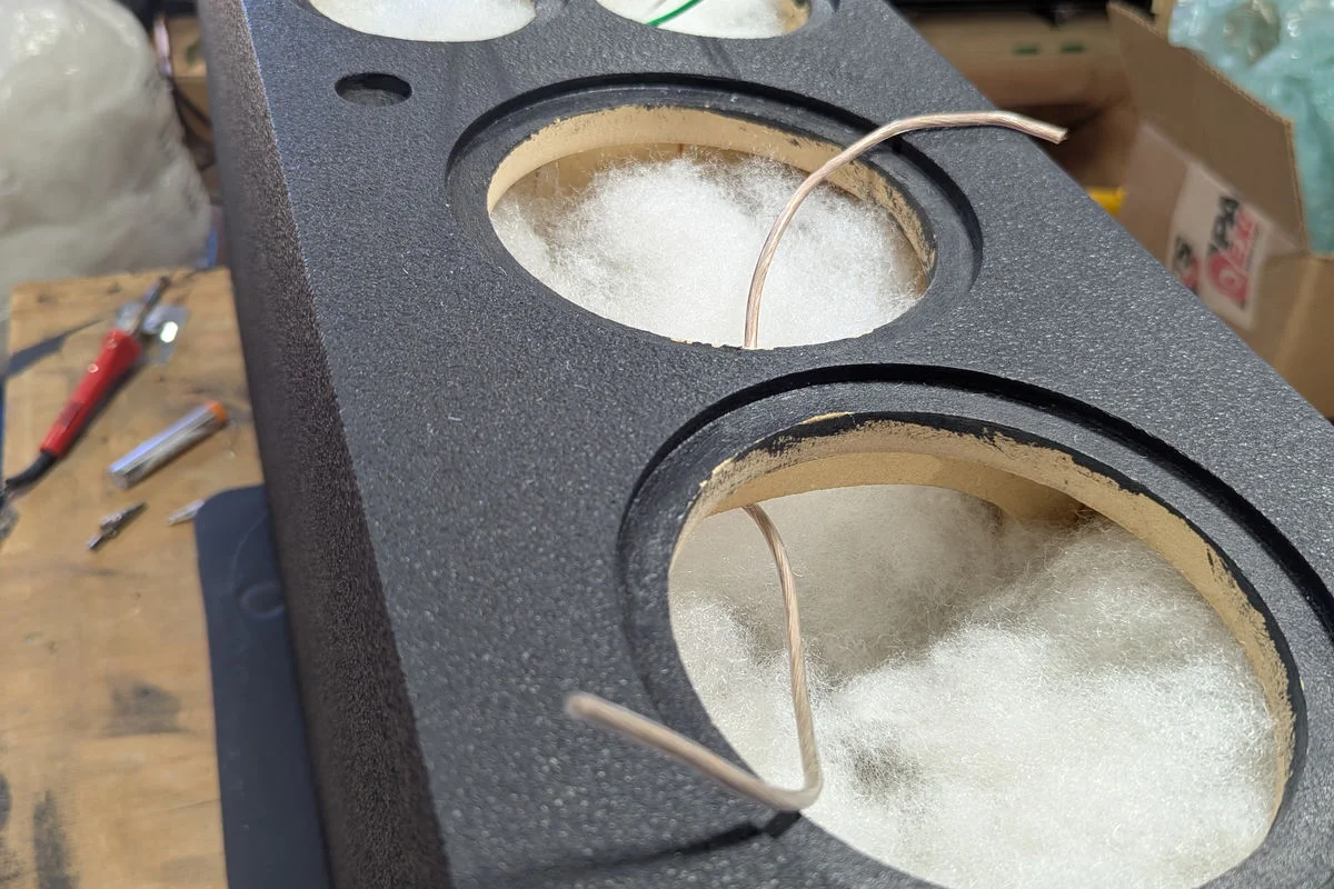 Inside a WubWub Audio speaker cabinet showing acoustic damping and precision wiring